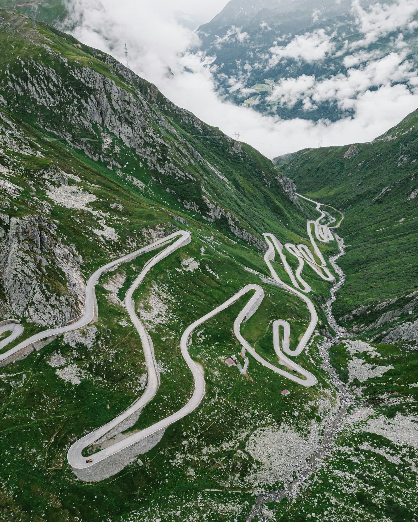 Aerial view of continuous mountain switchbacks climbing into the clouds